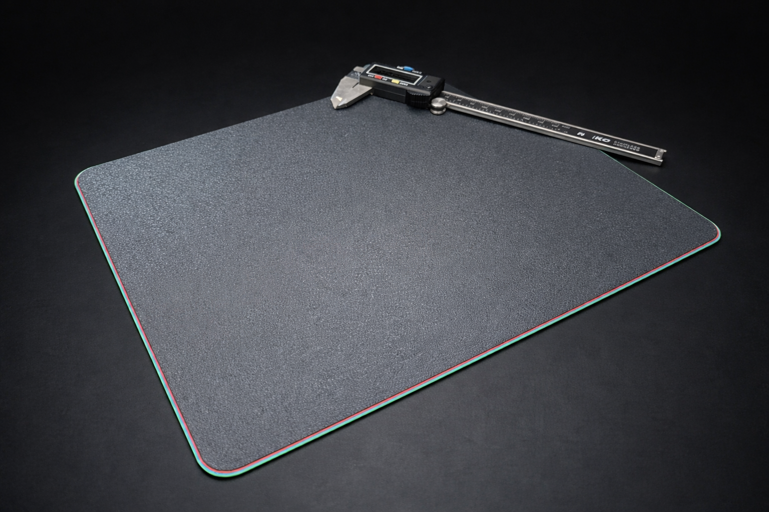 Finished 3D printed mousepad on a desk beside a mouse and keyboard.