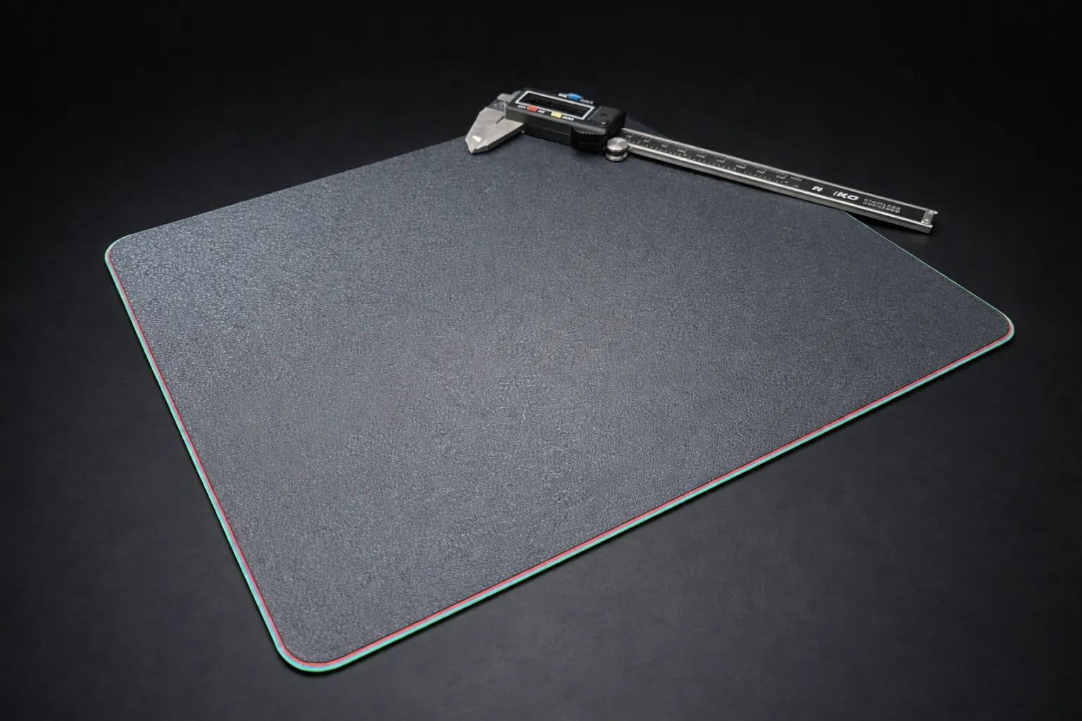 Finished 3D printed mousepad on a desk beside a mouse and keyboard.